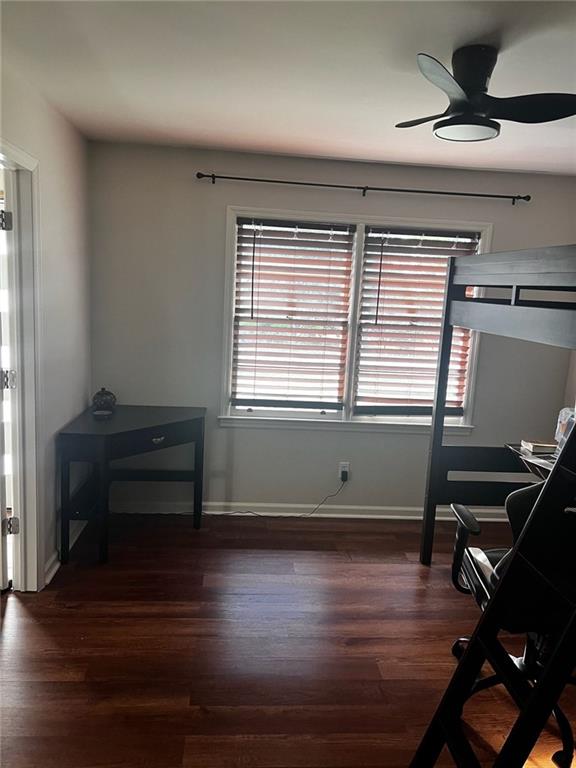 sitting room with a ceiling fan, dark wood-style floors, and baseboards