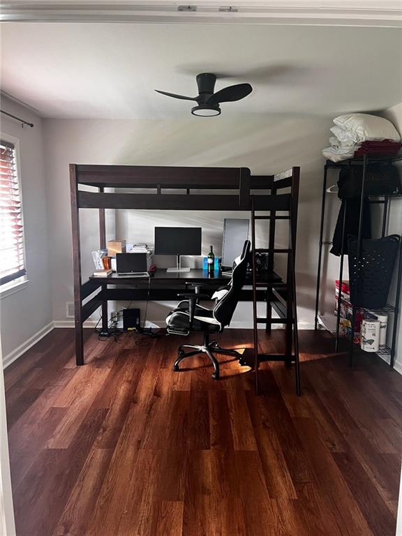 bedroom with baseboards and wood finished floors