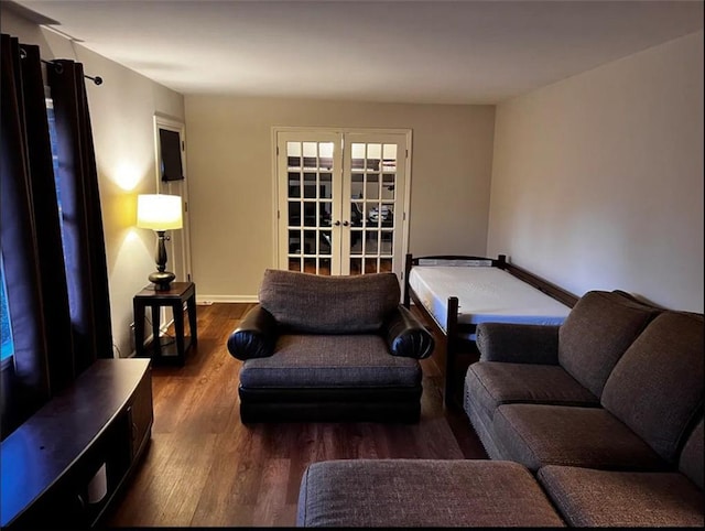 living room featuring french doors and dark wood-style flooring