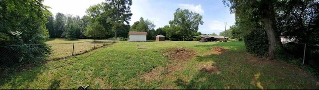 view of yard with an outdoor structure and fence