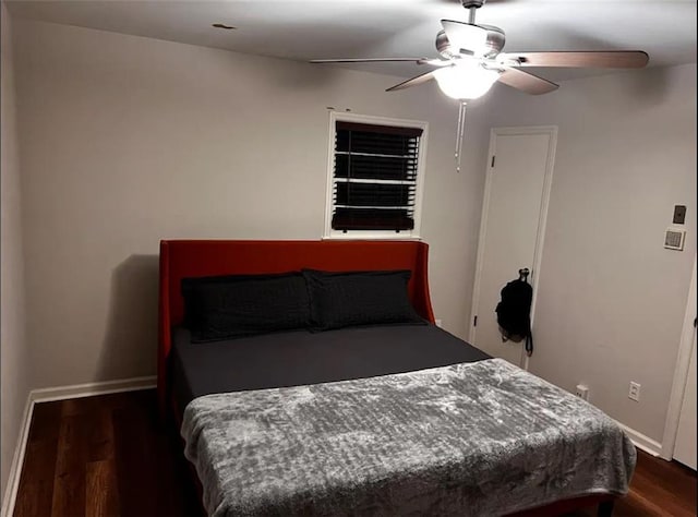 bedroom with wood finished floors, baseboards, and ceiling fan