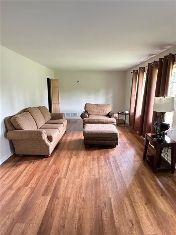 living room with visible vents and light wood-type flooring