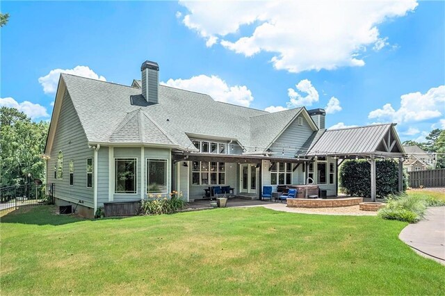 back of property with a patio and a lawn