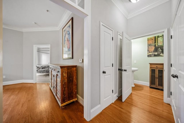 corridor with hardwood / wood-style floors and crown molding