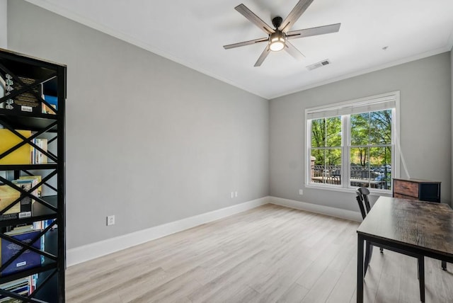 home office with crown molding, ceiling fan, and light hardwood / wood-style floors