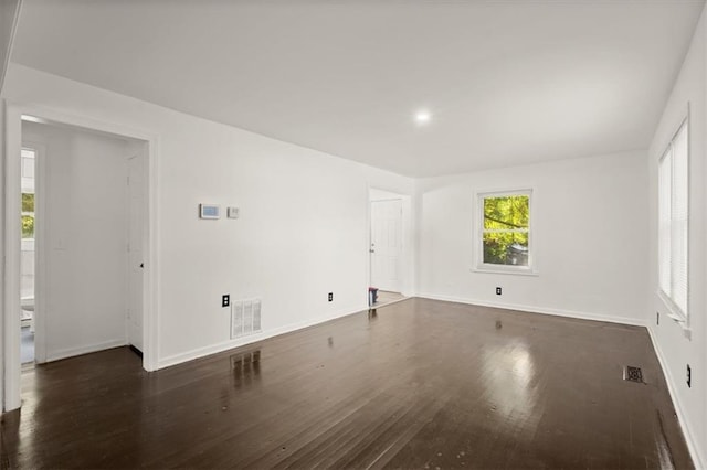 spare room with dark hardwood / wood-style floors