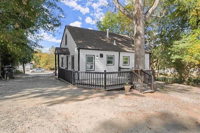 rear view of property with a wooden deck