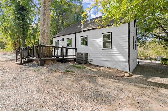 back of house with a deck and cooling unit