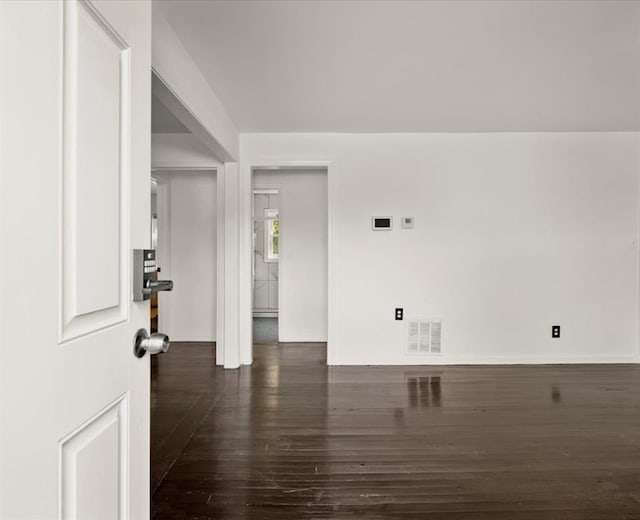 unfurnished room featuring dark hardwood / wood-style flooring