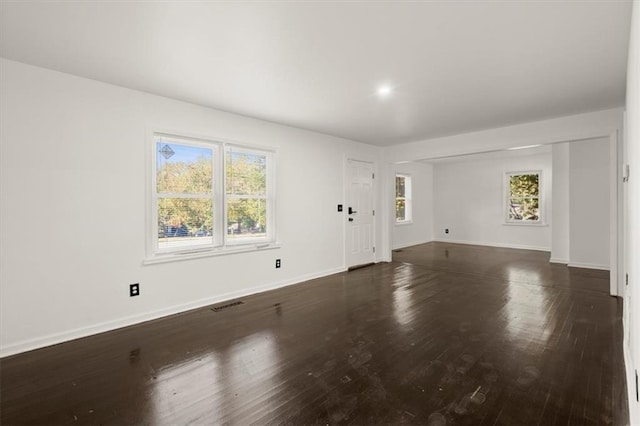 spare room with dark wood-type flooring