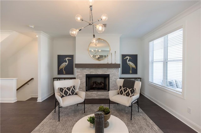 living area with ornamental molding, a notable chandelier, and an upstairs landing