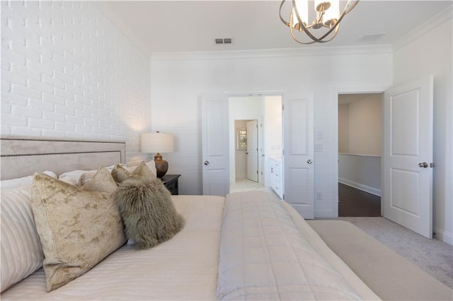 bedroom featuring brick wall, an inviting chandelier, visible vents, and crown molding