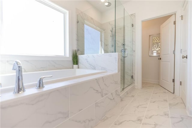 bathroom featuring marble finish floor, a garden tub, and a marble finish shower