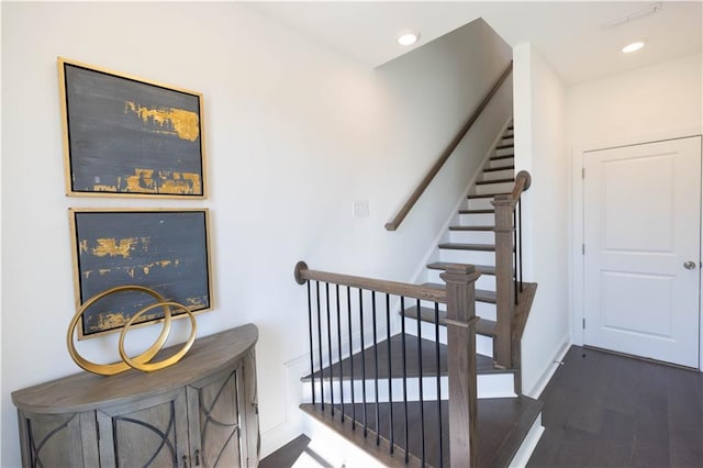 staircase featuring recessed lighting, baseboards, and wood finished floors