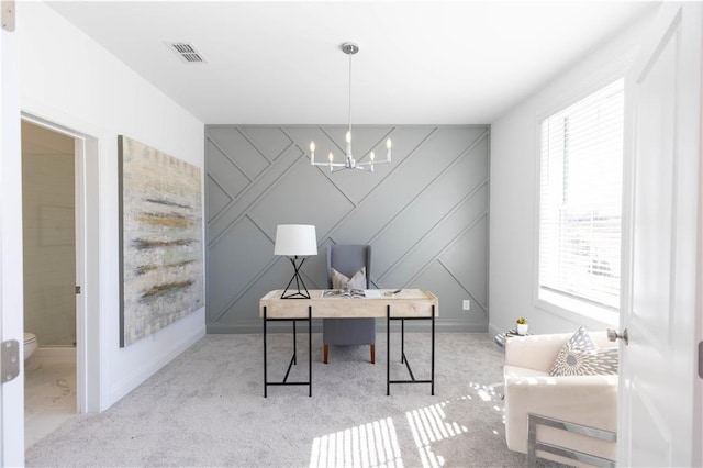 office space featuring a chandelier, light colored carpet, an accent wall, and visible vents