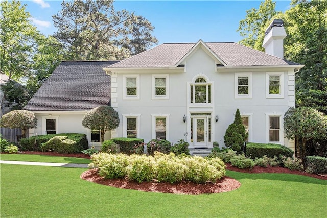 colonial-style house with a front lawn