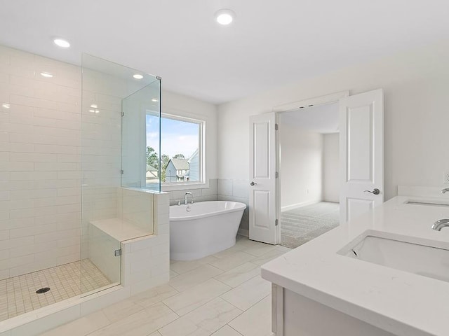 bathroom with vanity and separate shower and tub