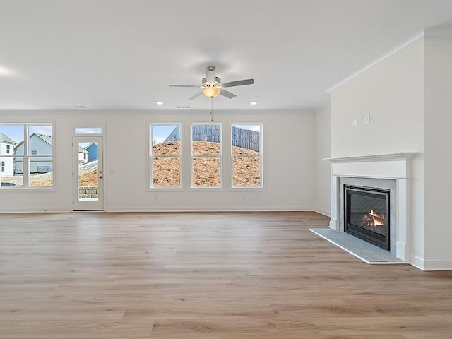 unfurnished living room with light hardwood / wood-style floors, crown molding, and ceiling fan