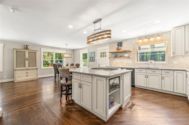 1382 Varner Rd, Marietta, GA 30062 - kitchen featuring a sink, a kitchen island, dark wood-style floors, baseboards, and hanging light fixtures
