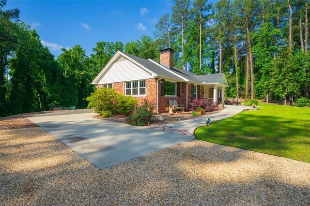 1382 Varner Rd, Marietta, GA 30062 - view of front facade featuring brick siding, a chimney, and a front yard