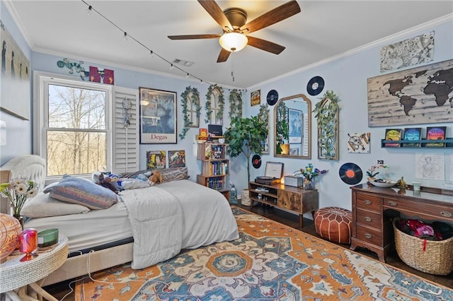 bedroom with ornamental molding, hardwood / wood-style floors, and ceiling fan