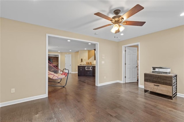 empty room with dark hardwood / wood-style flooring and ceiling fan