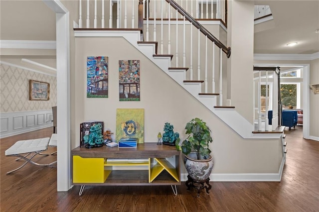 staircase featuring crown molding and wood-type flooring