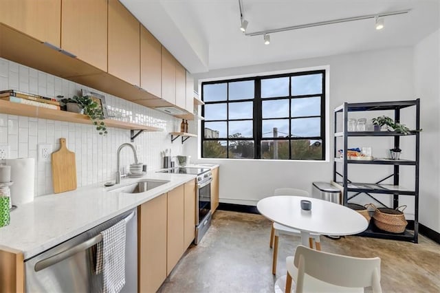 kitchen with concrete floors, rail lighting, open shelves, stainless steel appliances, and a sink