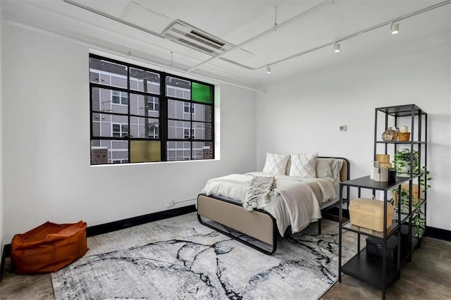 bedroom featuring concrete floors, baseboards, and visible vents