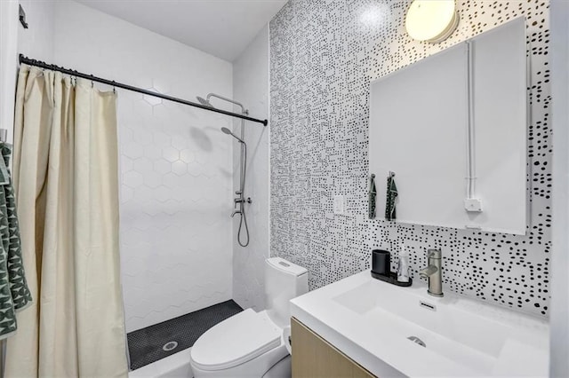 bathroom with toilet, tile walls, a tile shower, vanity, and decorative backsplash