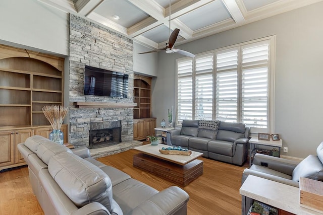486 Gold Bullion Dr E, Dawsonville, GA 30534 - living room featuring a stone fireplace, ceiling fan, beamed ceiling, coffered ceiling, and crown molding