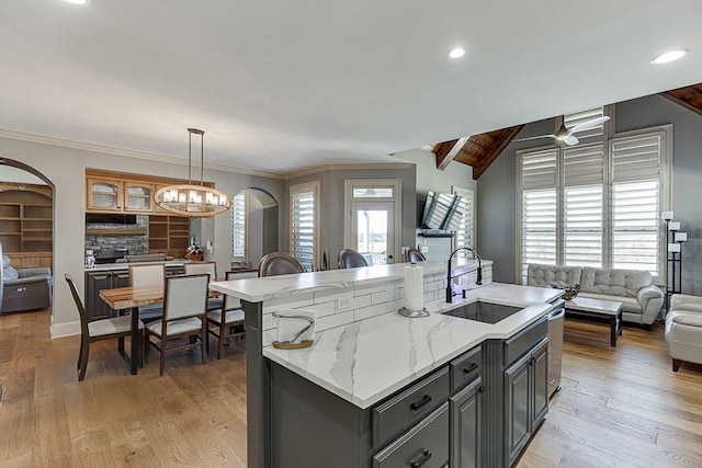 486 Gold Bullion Dr E, Dawsonville, GA 30534 - kitchen with a sink, open floor plan, gray cabinets, arched walkways, and recessed lighting