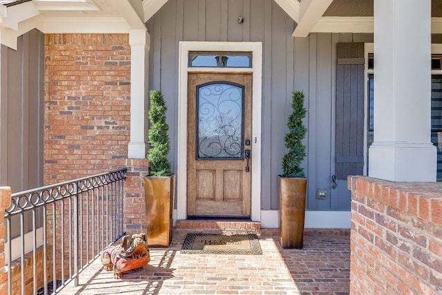 486 Gold Bullion Dr E, Dawsonville, GA 30534 - property entrance with a porch, brick siding, and board and batten siding