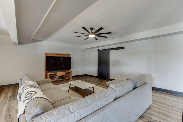 486 Gold Bullion Dr E, Dawsonville, GA 30534 - living area with a barn door, baseboards, ceiling fan, and wood finished floors