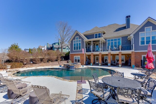 486 Gold Bullion Dr E, Dawsonville, GA 30534 - view of swimming pool with a patio and a pool with connected hot tub