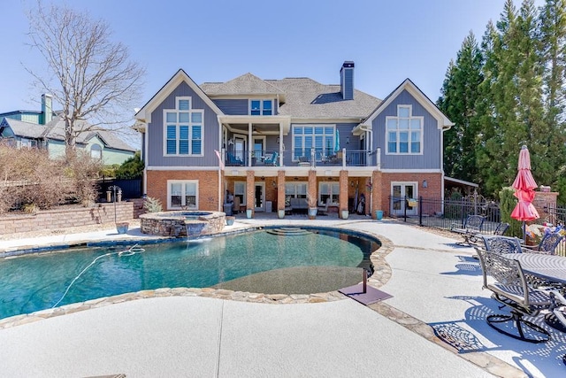 486 Gold Bullion Dr E, Dawsonville, GA 30534 - rear view of house featuring a balcony, brick siding, a chimney, a patio area, and board and batten siding