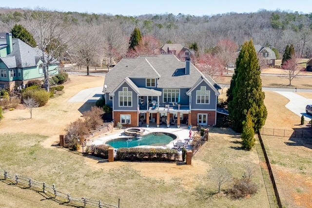 486 Gold Bullion Dr E, Dawsonville, GA 30534 - rear view of property with a fenced backyard, a balcony, brick siding, a patio, and a pool with connected hot tub