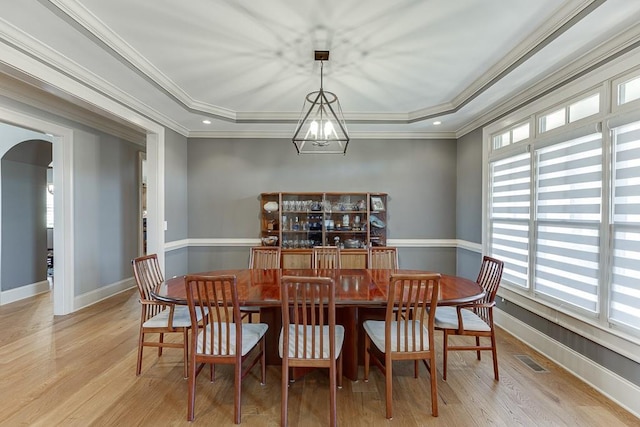 486 Gold Bullion Dr E, Dawsonville, GA 30534 - dining room featuring a raised ceiling, arched walkways, plenty of natural light, and ornamental molding