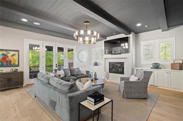 2583 Apple Valley Rd, Brookhaven, GA 30319 - living room with french doors, beam ceiling, a chandelier, light wood-type flooring, and a fireplace with flush hearth