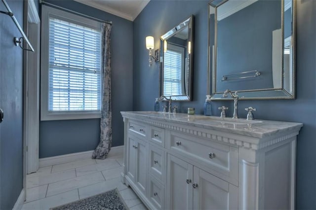 full bathroom featuring double vanity, baseboards, ornamental molding, and a sink