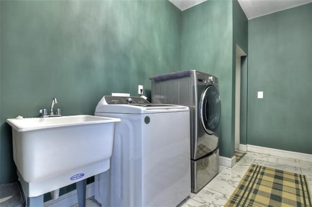 laundry room featuring marble finish floor, a sink, laundry area, independent washer and dryer, and baseboards