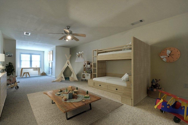 bedroom with carpet floors, visible vents, and a ceiling fan