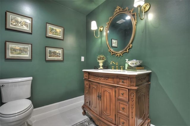 bathroom featuring tile patterned flooring, toilet, vanity, and baseboards