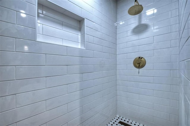 bathroom with a tile shower