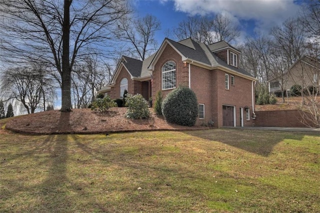 view of home's exterior with brick siding and a yard