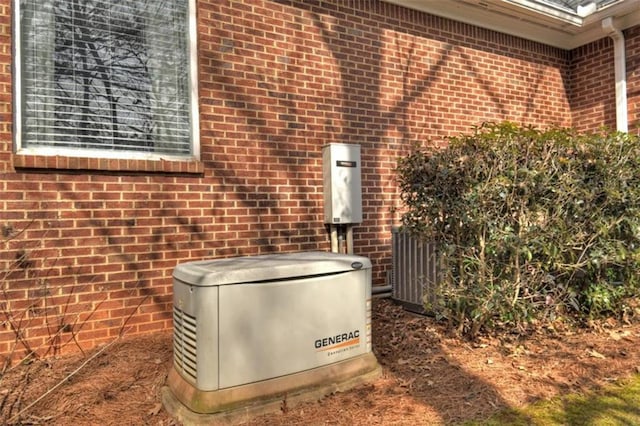 details with central air condition unit, a power unit, and brick siding