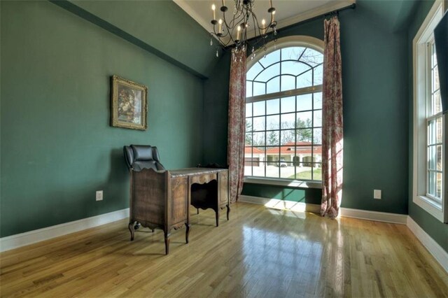 office with a chandelier, wood finished floors, and baseboards