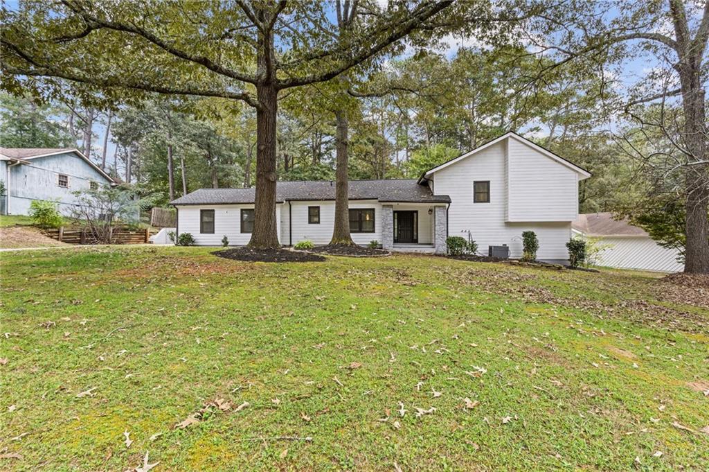 tri-level home with a front lawn