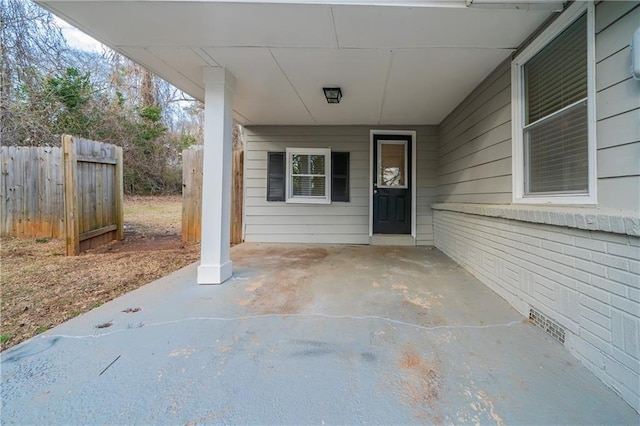 view of exterior entry featuring a patio