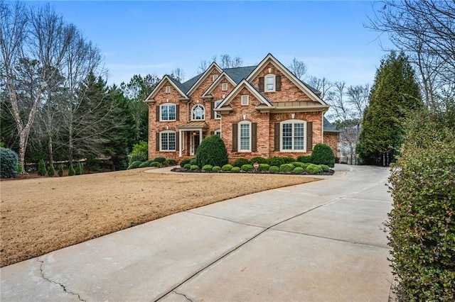 view of front of home featuring a front yard and brick siding